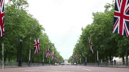 The Mall in London, UK. Leading to Buckingham Palace with Union Flags up. Also know as Pall Mall. Stock Video Clip Footage photo