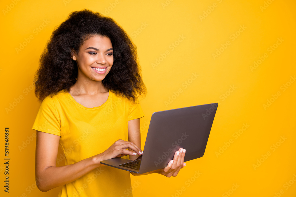 Close-up portrait of her she nice attractive lovely cheerful wavy-haired girl holding in hands laptop creating project isolated over bright vivid shine vibrant yellow color background Close-up portrait of her she nice attractive lovely cheerful wavy-haired girl holding in hands laptop creating project isolated over bright vivid shine vibrant yellow color background