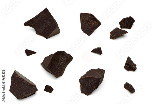 Cracked chocolates / broken chocolate chips or chocolate parts top view isolated on white background