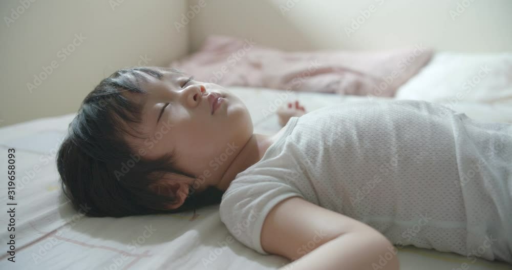 Kids asleep on bed in day time Kids asleep on bed in day time