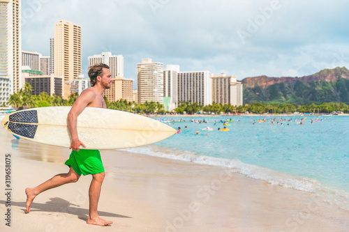 Photography Hawaii surfer man going surfing with surfboard on Waikiki beach, Honolulu City, Oahu, Hawaii summer travel