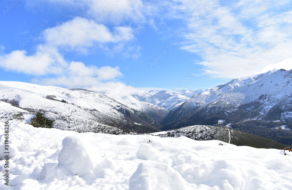 Winter landscape with snowy mountains and green valley with forest on a sunny day. Ancares, Lugo, Galicia, Spain. Winter landscape with snowy mountains and green valley with forest on a sunny day. Ancares, Lugo, Galicia, Spain.