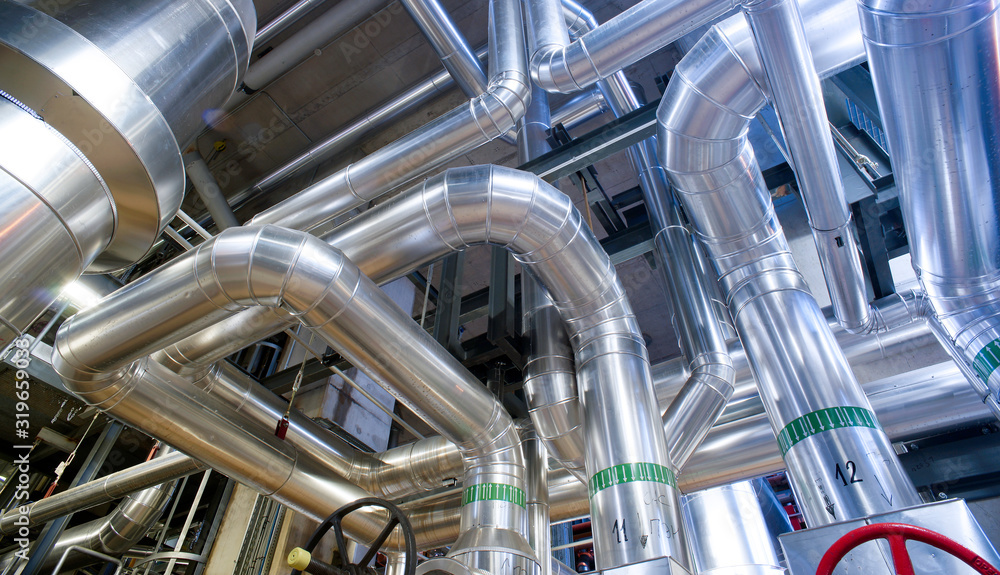 Equipment, cables and piping as found inside of a modern industrial power plant Equipment, cables and piping as found inside of a modern industrial power plant