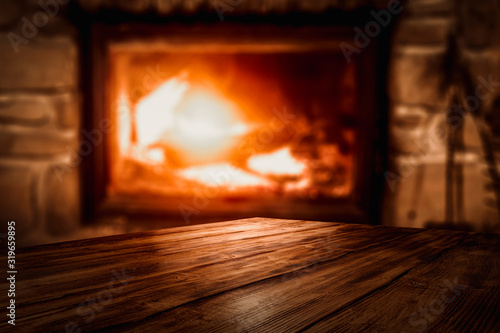 Desk of free space and blurred background of fireplace  © magdal3na