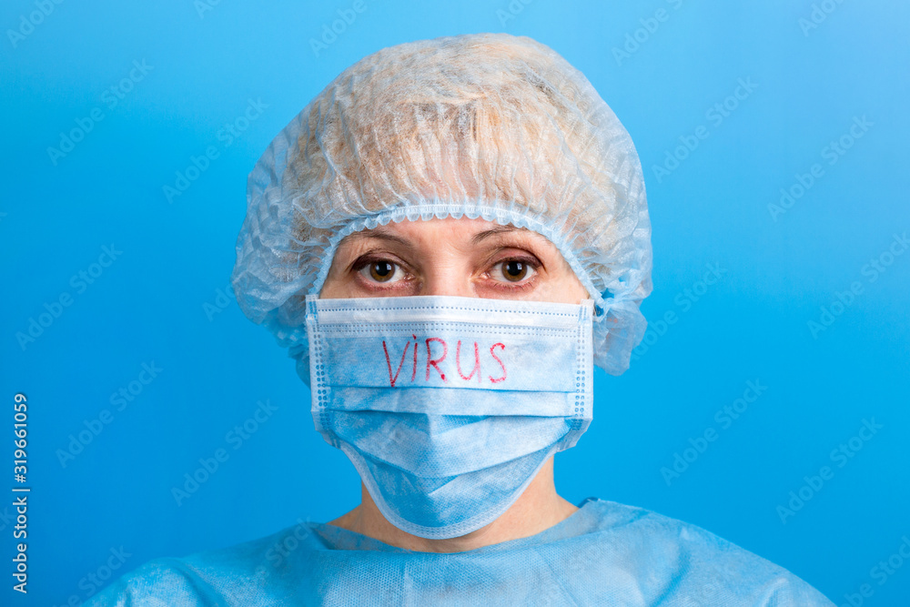 Portrait of sick woman wearing medical uniform and mask with virus word at blue background. Coronavirus and health care concept Portrait of sick woman wearing medical uniform and mask with virus word at blue background. Coronavirus and health care concept
