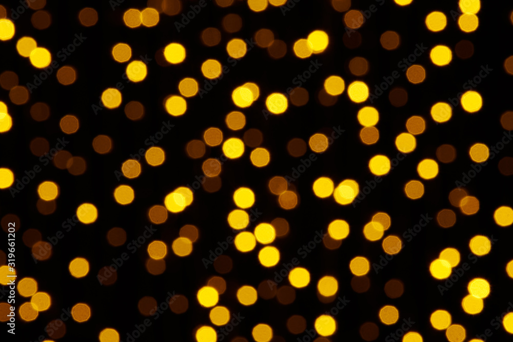 abstract background - photo of yellow bokeh on a black abstract background - photo of yellow bokeh on a black