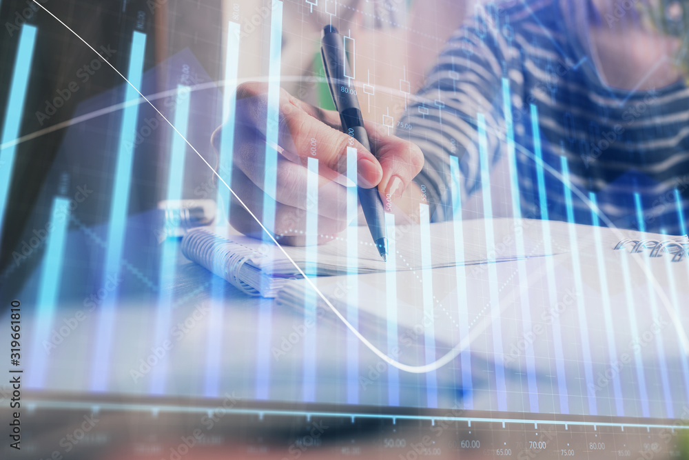 Financial forex graph drawn over hands taking notes background. Concept of research. Double exposure Financial forex graph drawn over hands taking notes background. Concept of research. Double exposure