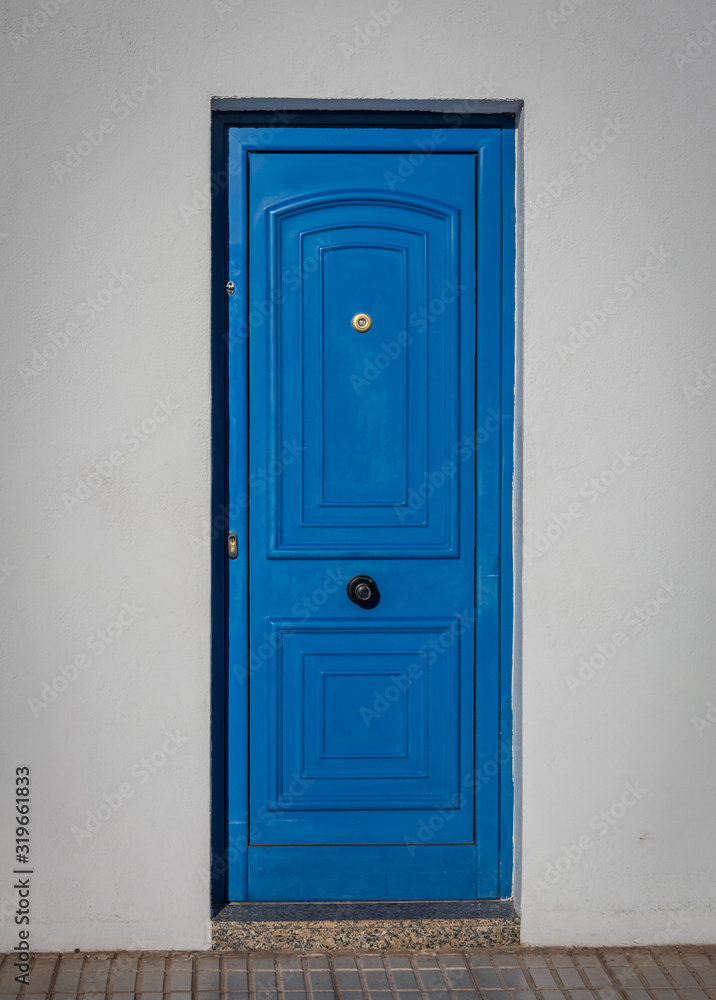 Blue door in sunlight on island Lanzarote, Canary Islands Blue door in sunlight on island Lanzarote, Canary Islands