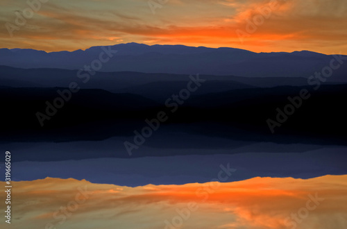 Sunset on the lake under the red and blue sky © vicenfoto