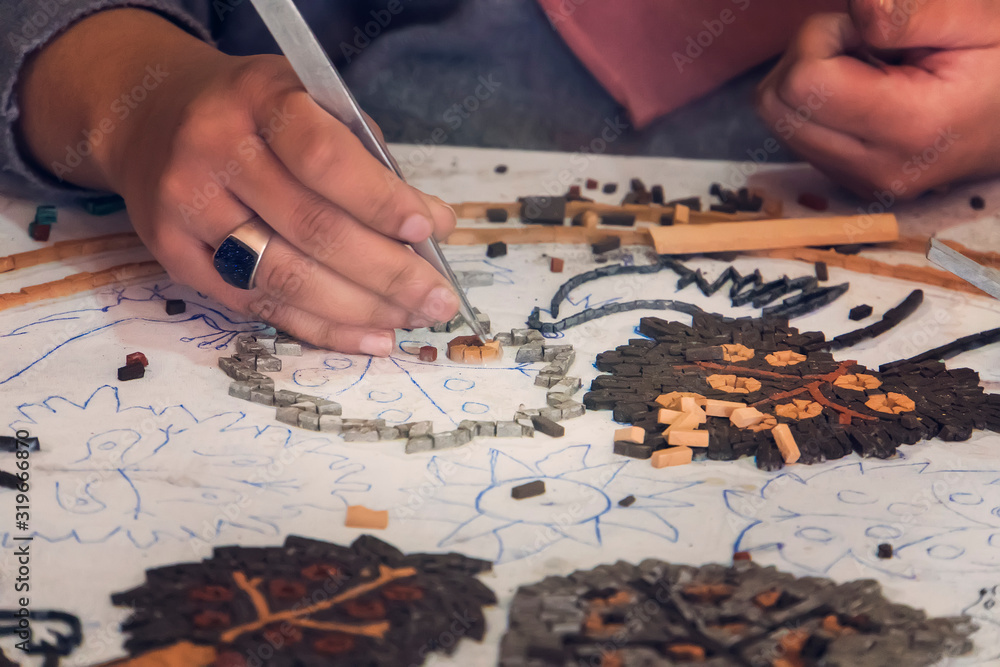 Artist, Mosaic Tools, Hand Craft, Uses Tweezers To Make Mosaic, Close Up.  Ancient process making mosaics. Stock Photo