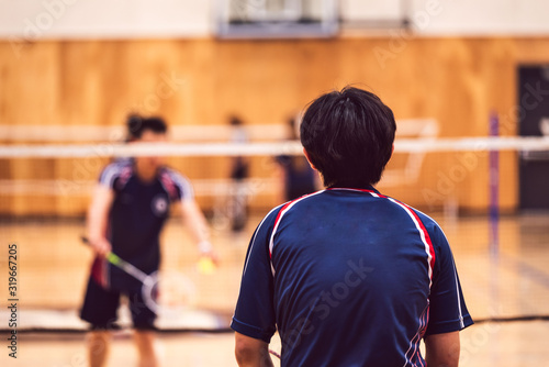 two boys playing badminton at the tournament