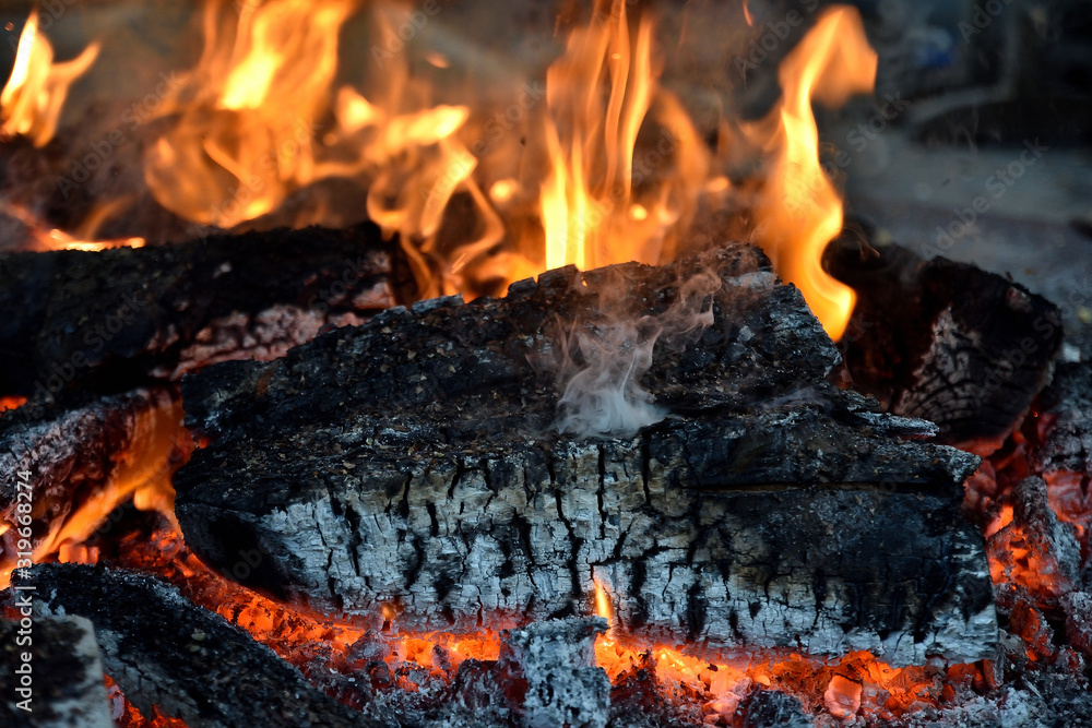 logs of wood with flames and burning embers in the fireplace logs of wood with flames and burning embers in the fireplace