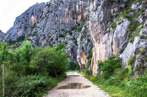 Gravel road through mountains near river, Omis, Croatia