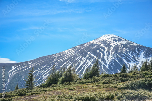 View of valley and mountain peaks in Carpathian mountains during sunny summer day, Ukraine photo