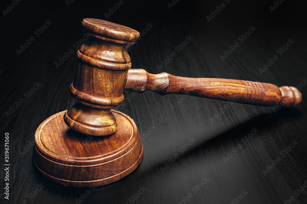 Wooden mallet on black wooden table close up Wooden mallet on black wooden table close up