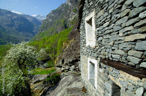 Old Rustic House and Mountain in Ticino, Switzerland. photo