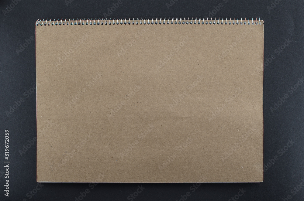 Blank brown notebook with space for text on black background. Empty notebook with brown texture. Copy space for add text or art work designs. Blank brown notebook with space for text on black background. Empty notebook with brown texture. Copy space for add text or art work designs.