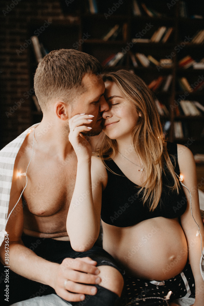 Happy man touching belly of smiling pregnant woman Happy man touching belly of smiling pregnant woman