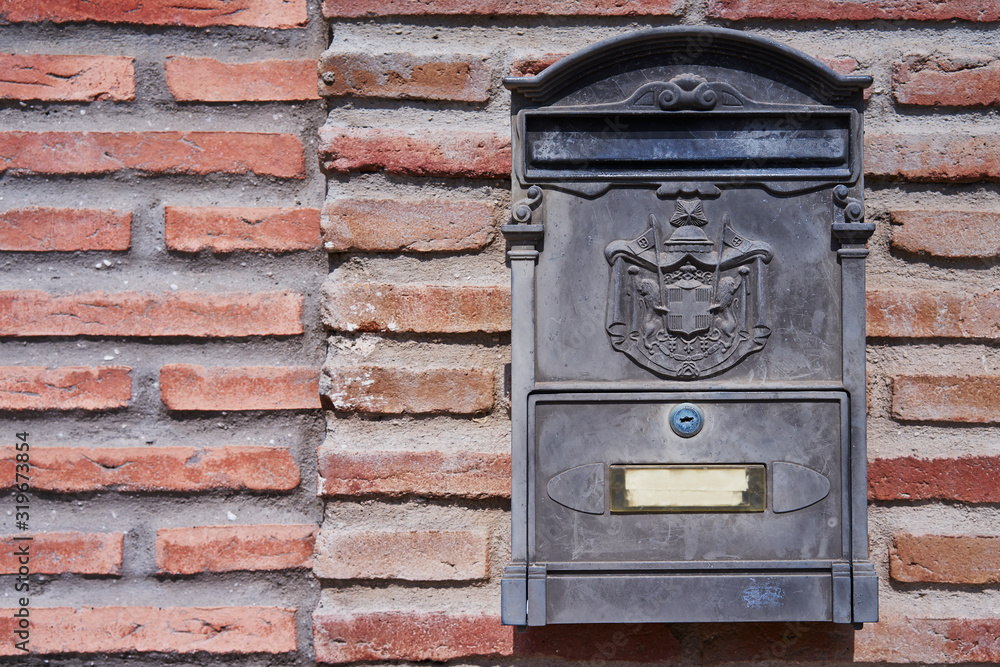 Mailbox covered on brick wall