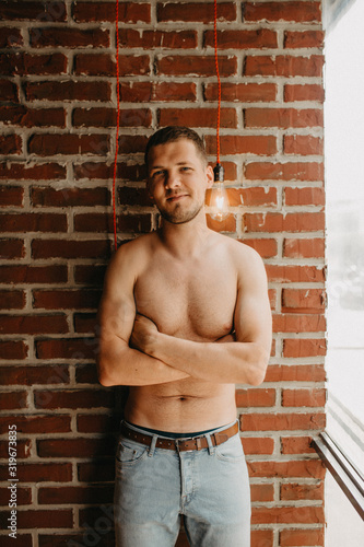 Shirtless sexy man have a rest alone in his bedroom at morning time.