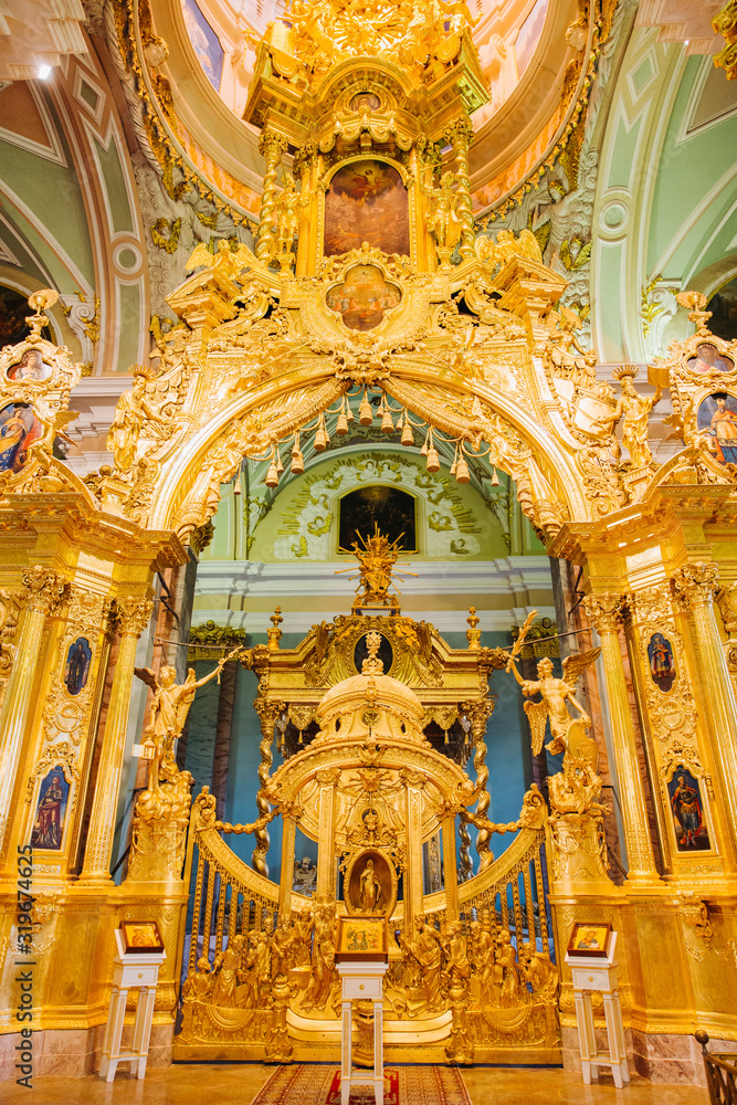 Icons, murals, angels and candles in the church. Golden Interior of Peter and Paul cathedral in Peter and Paul Fortress, St. Petersburg, Russia