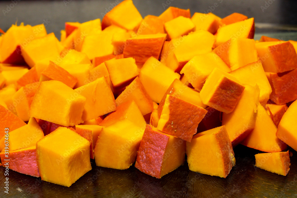 Diced pieces of pumpkin cut up and prepared for soup