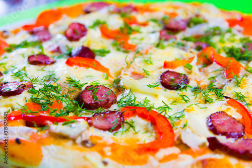 hot tasty fresh pizza on a plate close-up. green background