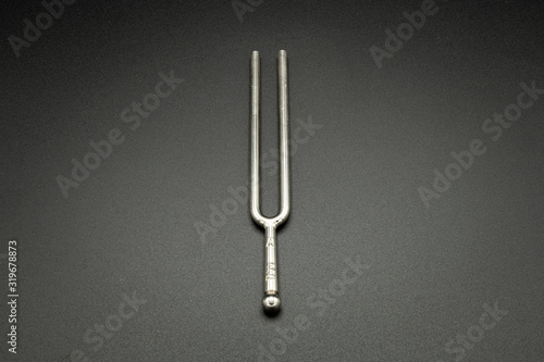 A tuning fork 440 Hz on a black background