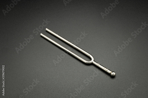 A tuning fork 440 Hz on a black background