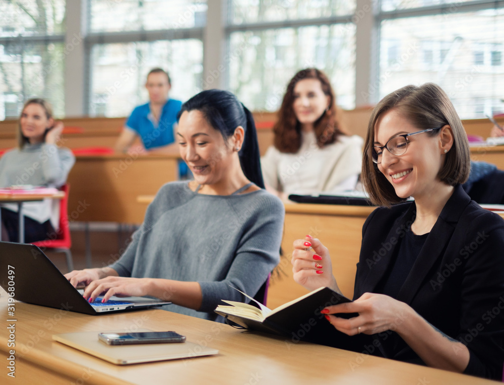 Lecturer and multinational group of students in an auditorium Lecturer and multinational group of students in an auditorium