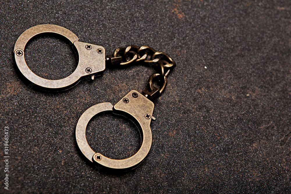 iron handcuffs road asphalt background