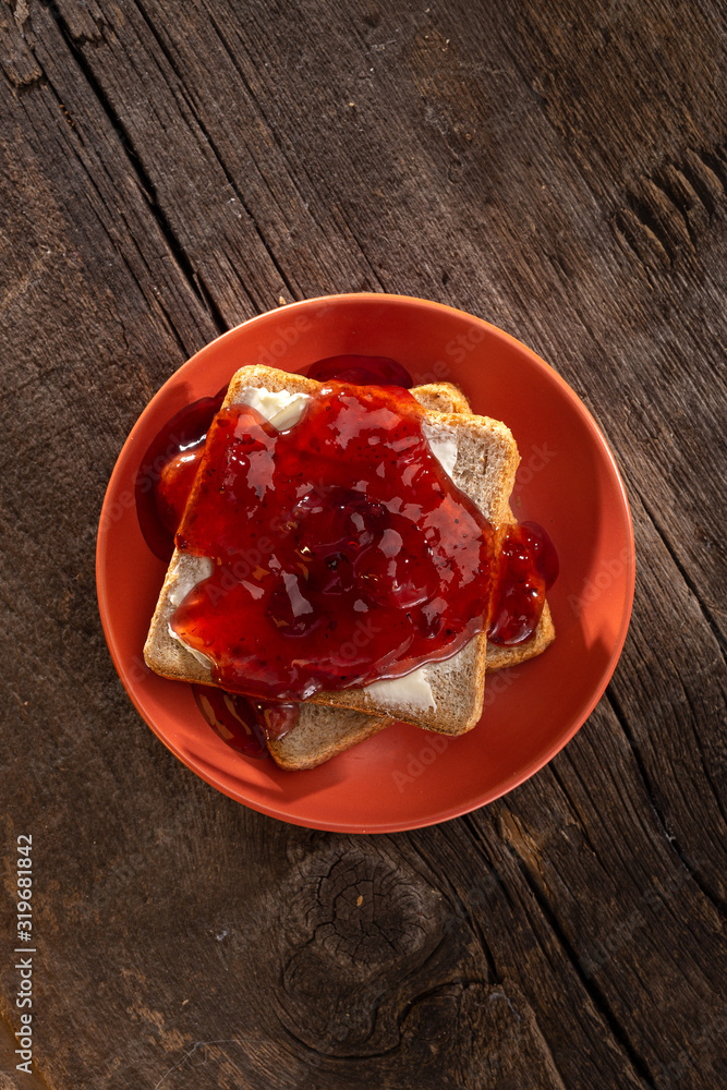 Crispy toast with butter, jam. fried crispy toasts with red jam on a table. breakfast. Crispy toast with butter, jam. fried crispy toasts with red jam on a table. breakfast.