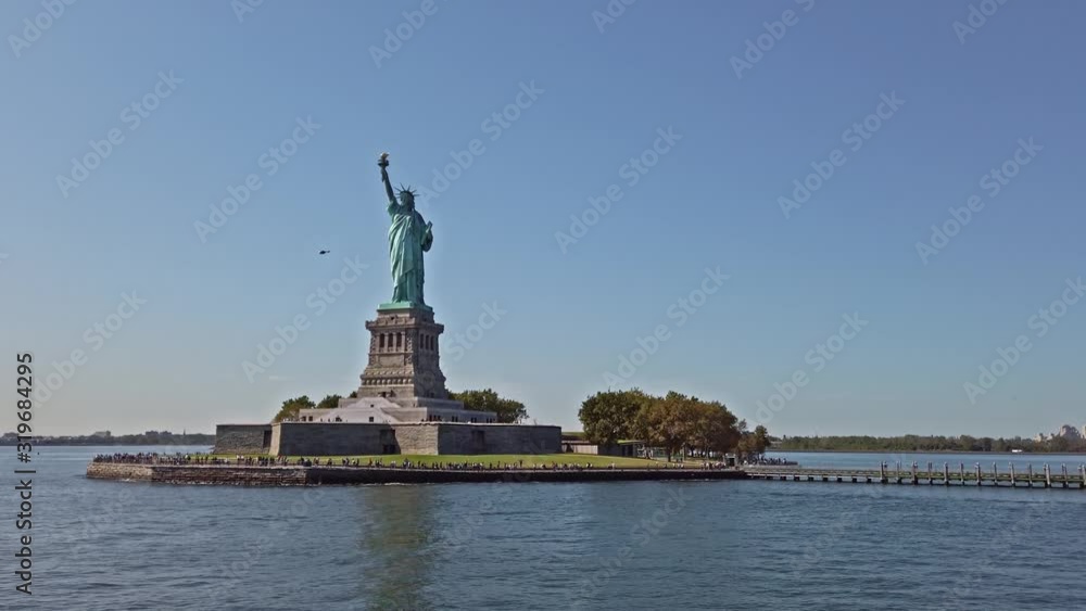 Statue of Liberty and walking people in New York Statue of Liberty and walking people in New York