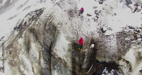 Himalayan mountaineers at Himalaya climbing peaks with high experience & high risk. Professional mountaineers at Himalayas. Ice axe use, pittons use by professional mountaineers. photo