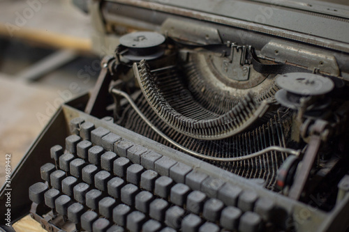 Old, antique typewriter close-up in the dust.