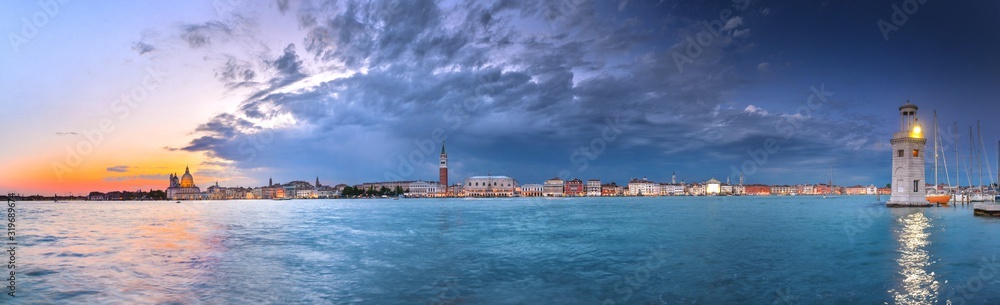 Panorama of Venice with many sights and the lighthouse in the evening