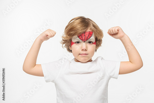 adorable boy with spiderman mask painted on face demonstrating power isolated on white