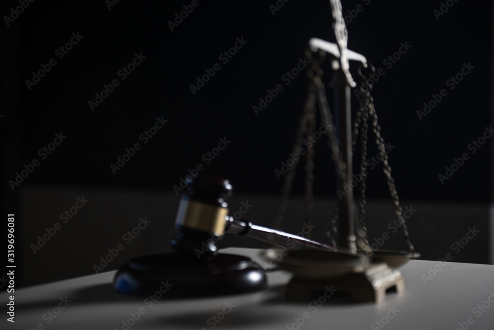 Law and Justice concept. Mallet of the judge, books, scales of justice. Dark Courtroom theme. Law and Justice concept. Mallet of the judge, books, scales of justice. Dark Courtroom theme.