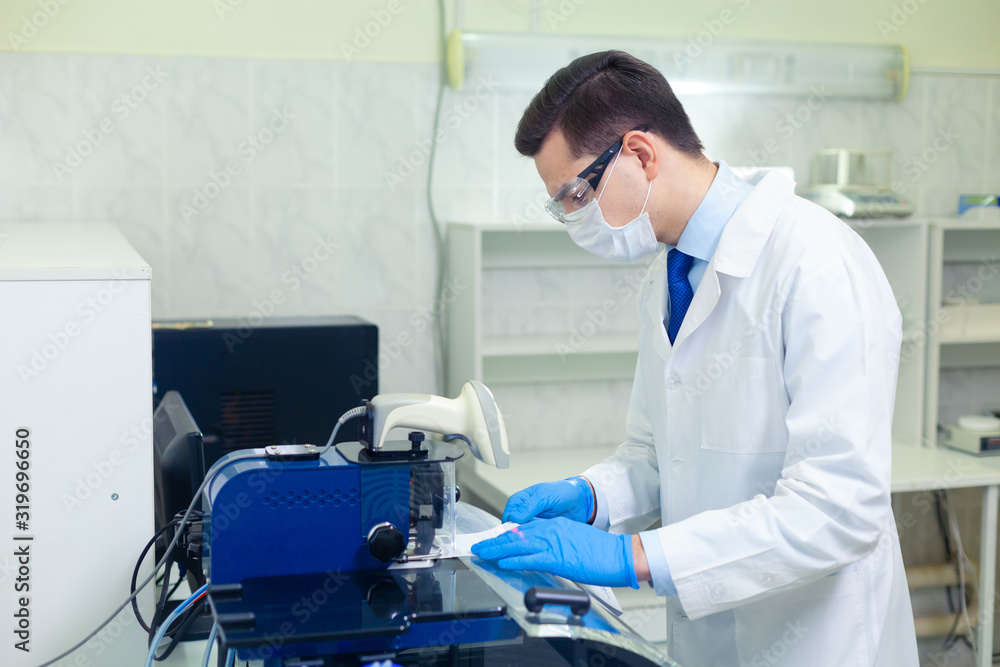 DNA laboratory. The expert puts the human DNA into the database using advanced laboratory technologies DNA laboratory. The expert puts the human DNA into the database using advanced laboratory technologies