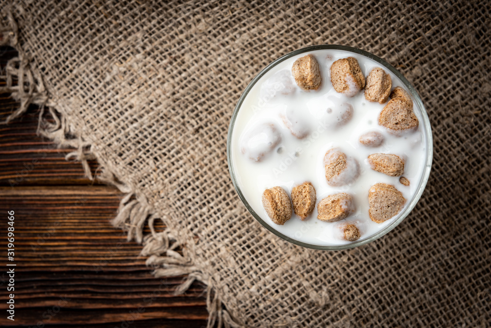 Rye bran and kefir on dark wooden background. Rye bran and kefir on dark wooden background.