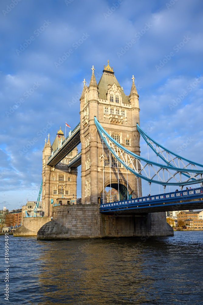 Fototapeta Tower Bridge in the City of London, UK. Tower Bridge crosses the River Thames and is one of the most famous tourist sights in London. Portrait view of Tower Bridge in late afternoon light.