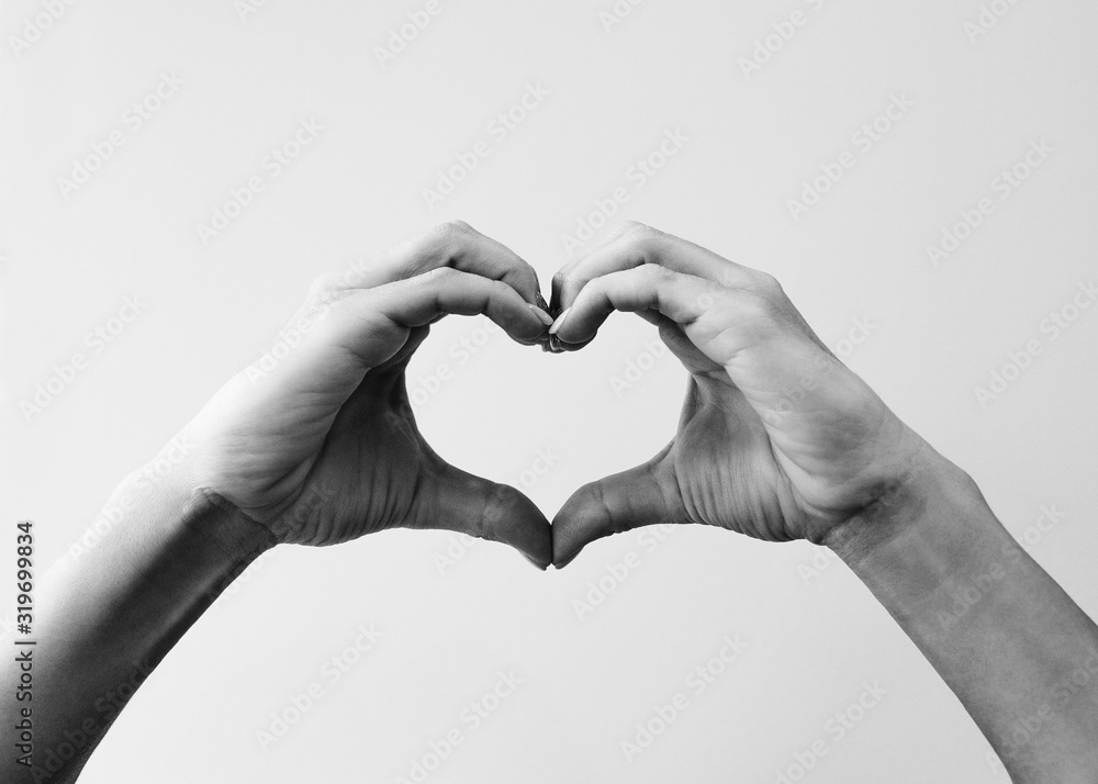 Female hands that make a heart shape. Heart shape with female hands.  Close-up. Sign of love. Black and white image Stock Photo