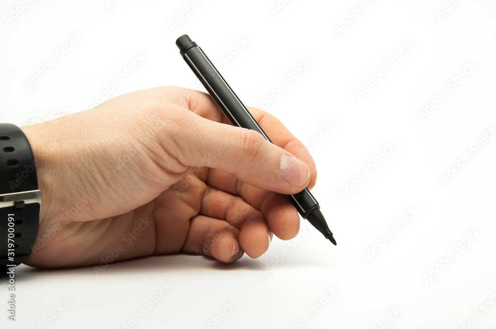 Black marker in the hands of a man. Writes on a blank sheet of paper. White background Black marker in the hands of a man. Writes on a blank sheet of paper. White background