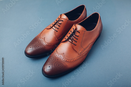 Oxford male brogues shoes. Men's fashion. Classical brown leather footwear.