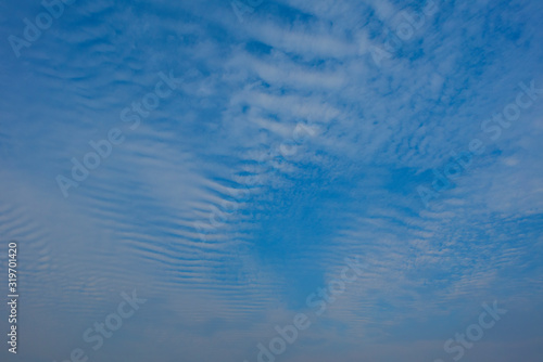 Blue sky with white clouds, (Cirrocumulus clouds)  in blue sky on sunny peaceful day.