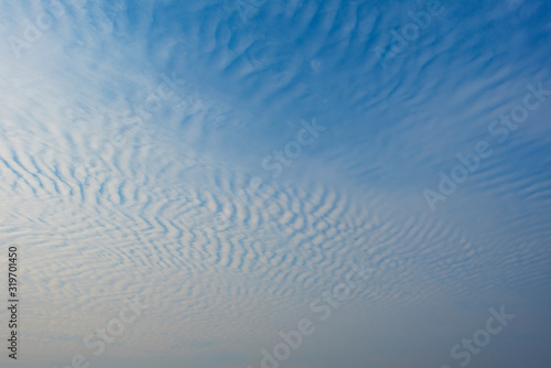 Blue sky with white clouds   Cirrocumulus clouds   in blue sky on sunny peaceful day.