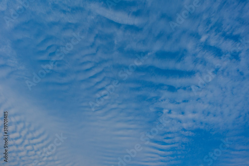 Blue sky with white clouds, (Cirrocumulus clouds) in blue sky on sunny peaceful day.