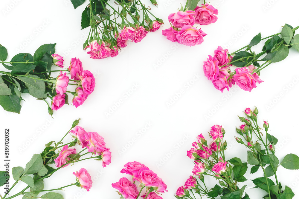 Floral frame with pink roses flowers on white background. Flat lay Floral frame with pink roses flowers on white background. Flat lay