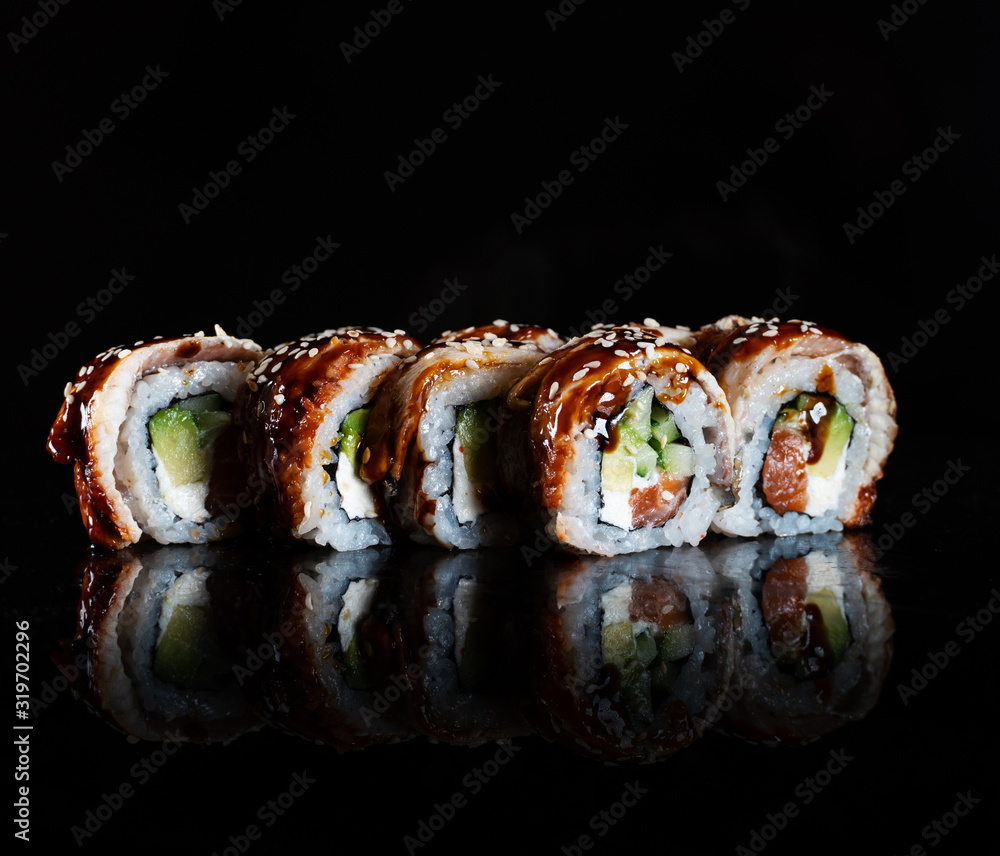 Japanese Sushi isolated on black background. Reflection in a mirror surface. Close up. Studio photo. Japanese Sushi isolated on black background. Reflection in a mirror surface. Close up. Studio photo.