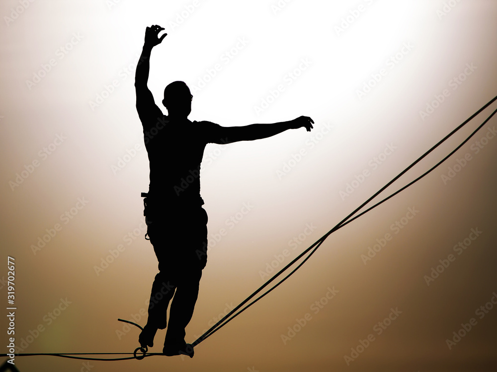 Fototapeta premium Slackliner balancing on highline